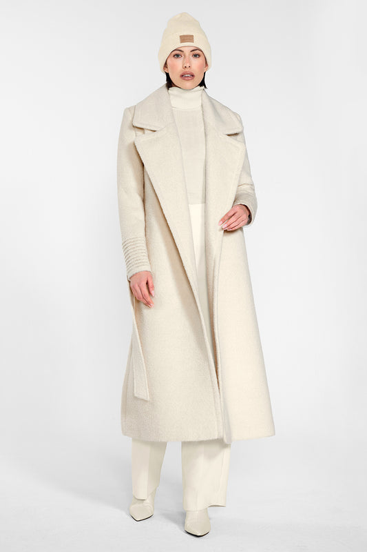 Sentaler Alpaca Beanie and the Bouclé Alpaca Long Notched Collar Wrap Coat crafted in Baby Alpaca and in Ivory White. Seen from front on female model.