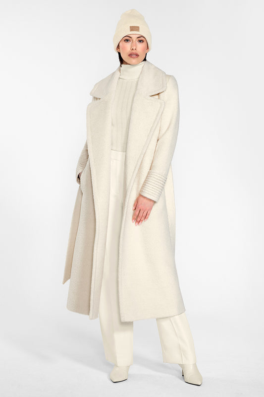 Sentaler Alpaca Beanie and the Bouclé Alpaca Long Notched Collar Wrap Coat crafted in Baby Alpaca and in Ivory White. Seen from front on female model.