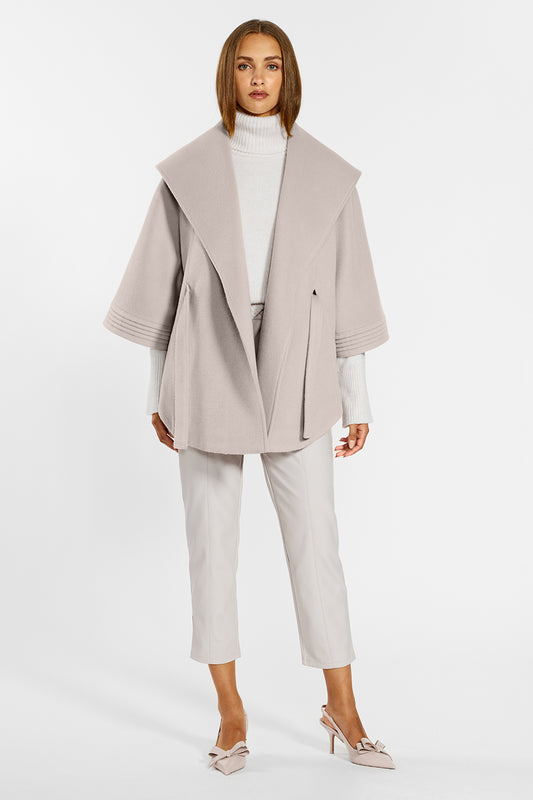 Sentaler Cape with Shawl Collar and Belt crafted in Baby Alpaca wool and in Bleeker Beige. Seen from front open on female model.