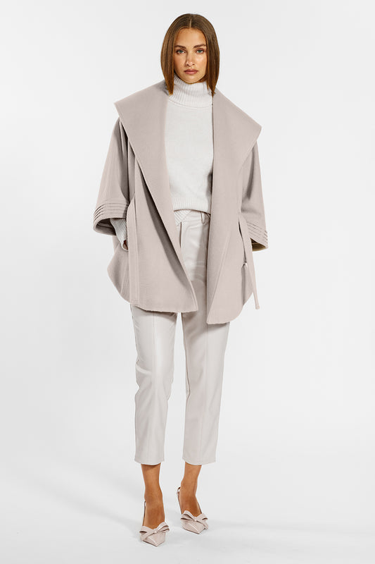 Sentaler Cape with Shawl Collar and Belt crafted in Baby Alpaca wool and in Bleeker Beige. Seen from front open on female model.