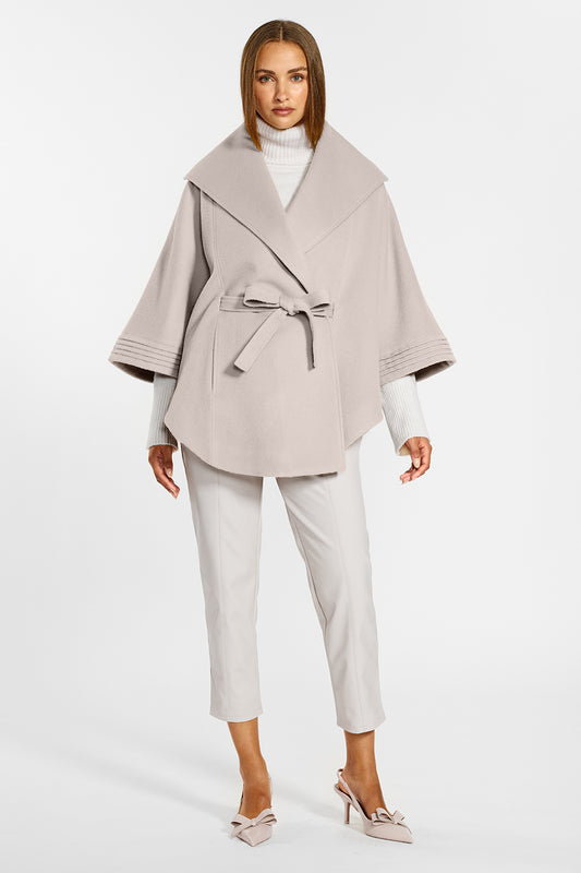 Sentaler Cape with Shawl Collar and Belt crafted in Baby Alpaca wool and in Bleeker Beige. Seen from front on female model.