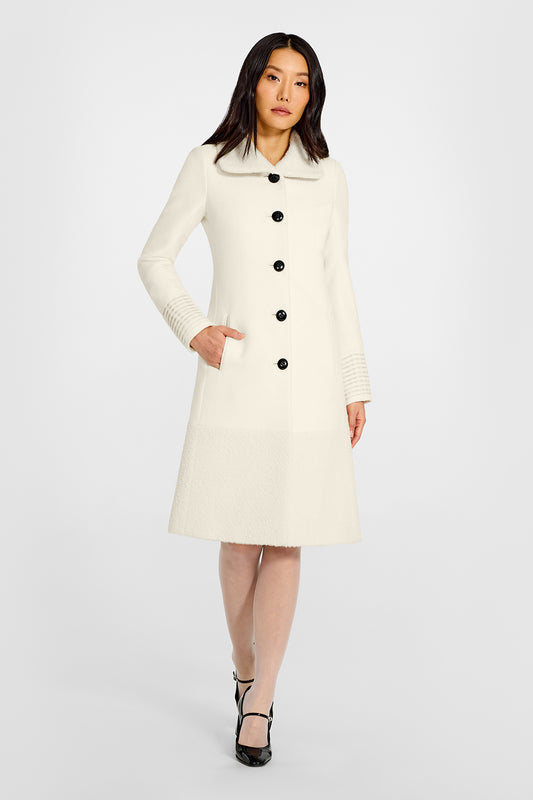 Sentaler A-line Ivory Coat with Bouclé Alpaca Collar and Trim in Baby Alpaca wool. Seen from front on female model.