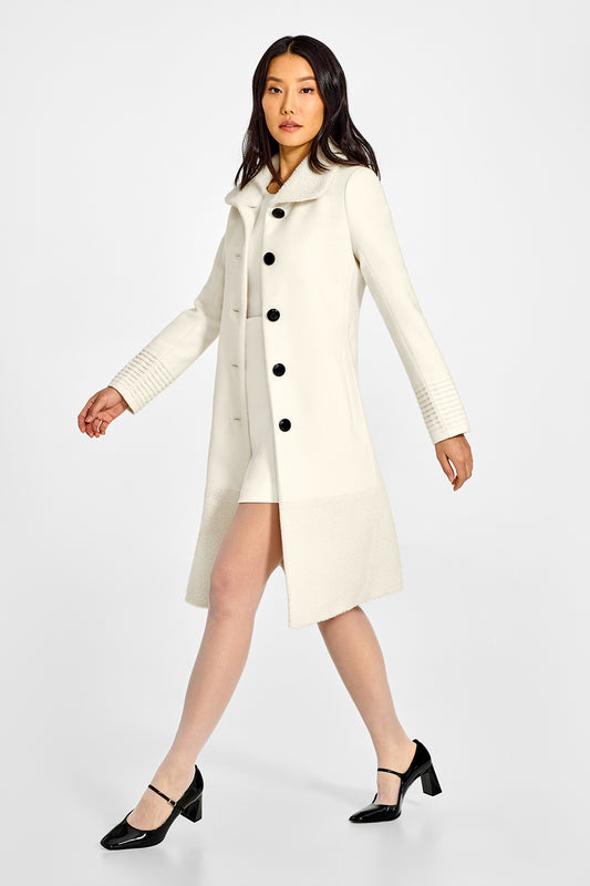 Sentaler A-line Ivory Coat with Bouclé Alpaca Collar and Trim in Baby Alpaca wool. Seen from side open on female model.