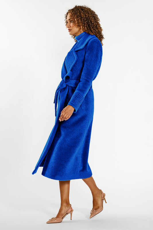 Sentaler Bouclé Alpaca Long Notched Collar Wrap Coat crafted in Bouclé Alpaca wool and in Cobalt Blue. Seen from side belted on female model.