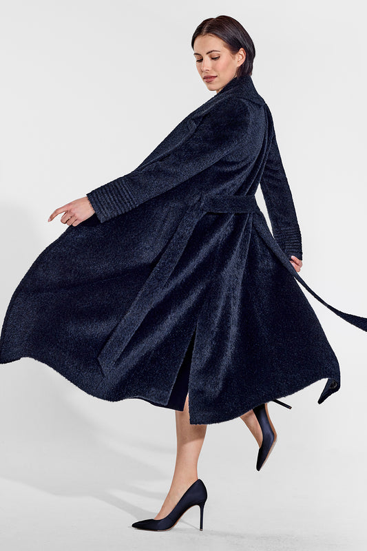 Sentaler Bouclé Alpaca Long Notched Collar Wrap Coat featured in Bouclé Alpaca and available in Midnight Blue. Seen from side on female model who is wearing the coat open.