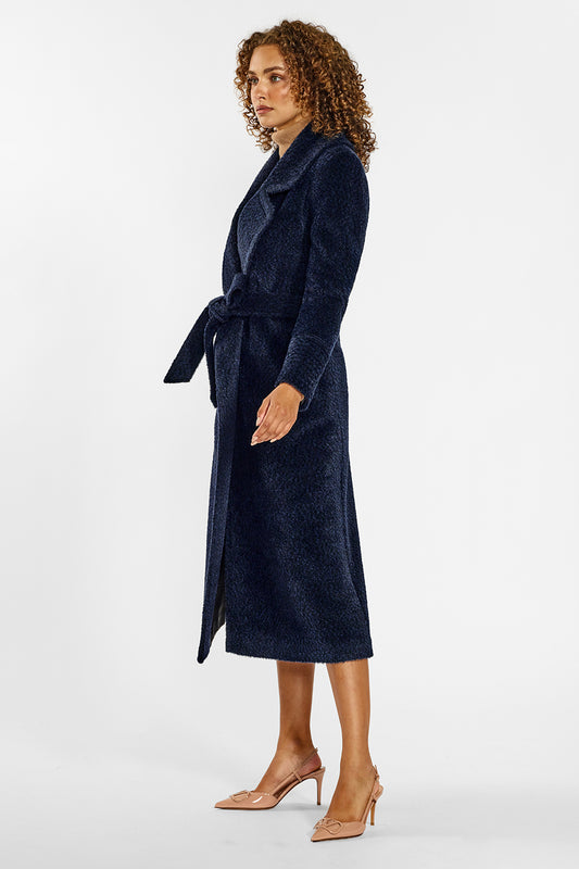 Sentaler Bouclé Alpaca Long Notched Collar Wrap Coat crafted in Bouclé Alpaca wool and in Midnight Blue. Seen from side belted on female model.