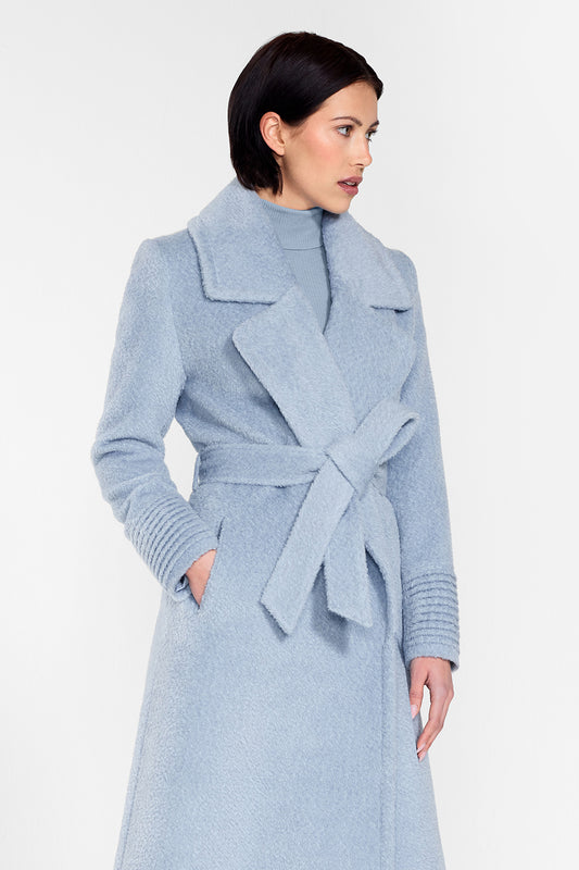 Sentaler Bouclé Alpaca Long Notched Collar Wrap Coat featured in Bouclé Alpaca and available in Powder Blue. Seen from side above the knees on female model wearing the coat belted.