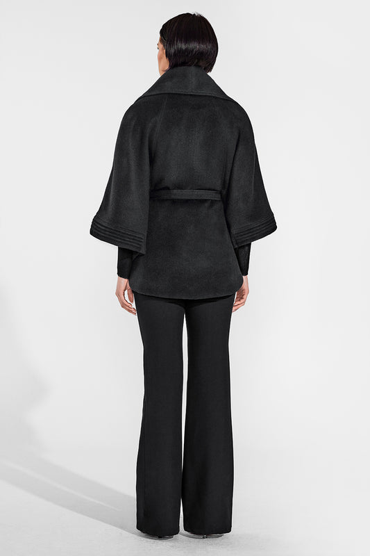 Sentaler Cape with Shawl Collar and Belt featured in Baby Alpaca and available in Black. Seen from back on female model who is wearing the cape belted.