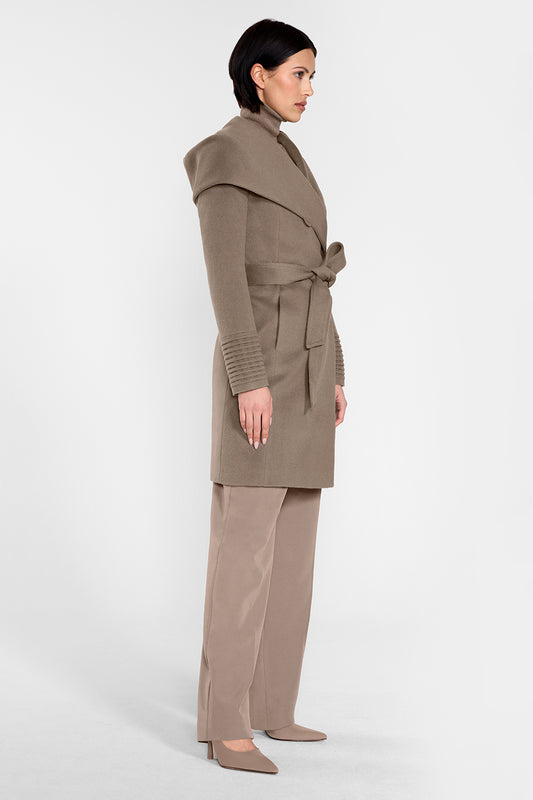 Sentaler Mid Length Hooded Wrap Coat featured in Baby Alpaca and available in Warm Taupe. Seen from side on female model who is wearing the coat belted.