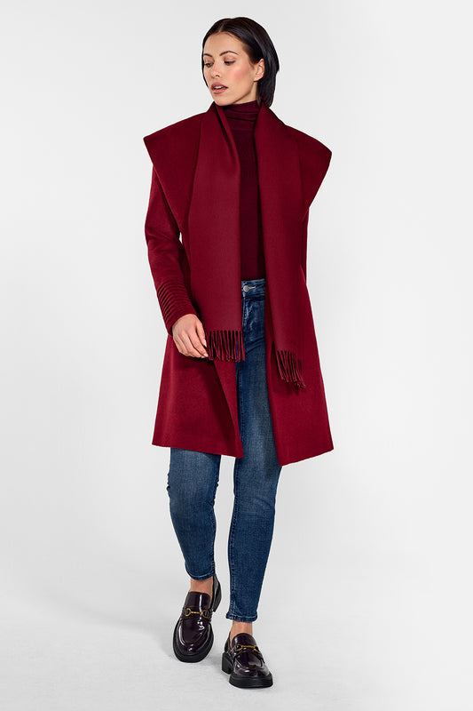 Sentaler Mid Length Shawl Collar Wrap Coat and Baby Alpaca Classic Scarf featured in Baby Alpaca and available in Garnet Red. Seen from front on female model who is wearing the coat open and the scarf draped around the neck.