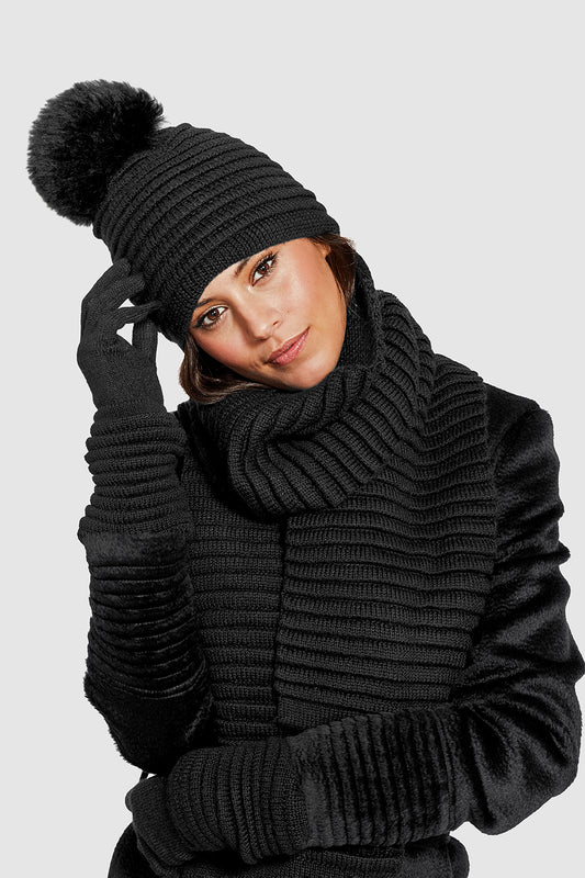 Sentaler Adult Ribbed Gloves, Adult Ribbed Hat with Oversized Fur Pompon, Adult Ribbed Scarf featured in Baby Alpaca and available in Black. Seen from front on model.