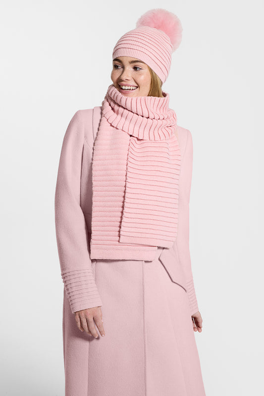 Sentaler Kids (1-5 Years) Ribbed Hat with Oversized Fur Pompon and Ribbed Scarf featured in Baby Alpaca and available in Pink. Seen from side on model.