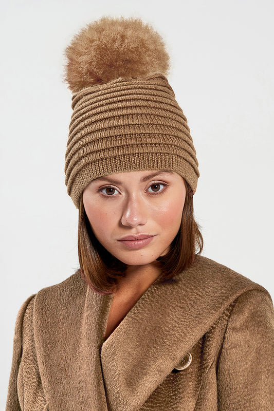 Sentaler Adult Ribbed Hat With Oversized Fur Pompon featured in Baby Alpaca and available in Dark Camel. Seen from front close up.