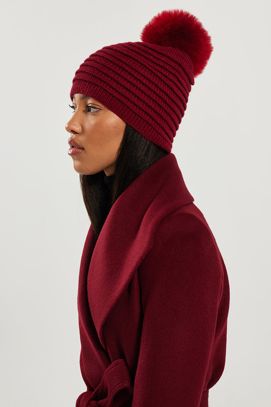 Sentaler Adult Ribbed Hat With Oversized Fur Pompon featured in Baby Alpaca and available in Garnet Red. Seen from side.