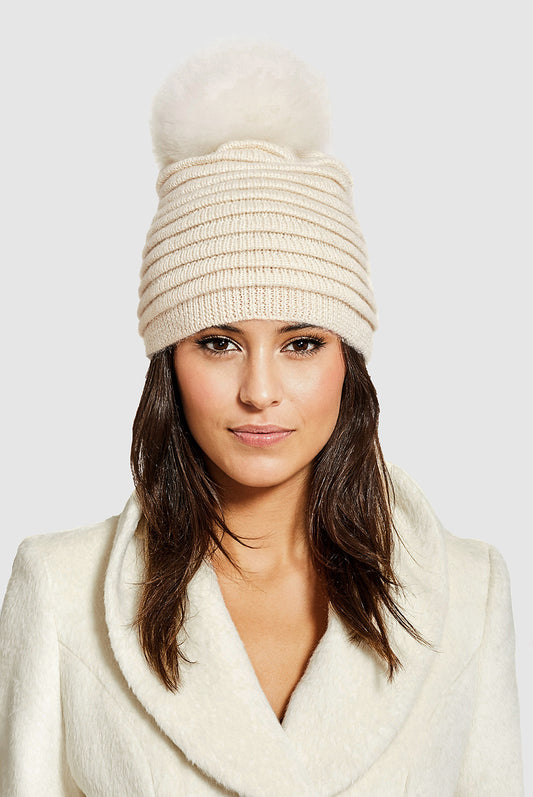 Sentaler Adult Ribbed Hat With Oversized Fur Pompon featured in Baby Alpaca and available in Ivory. Seen from front close up on model.