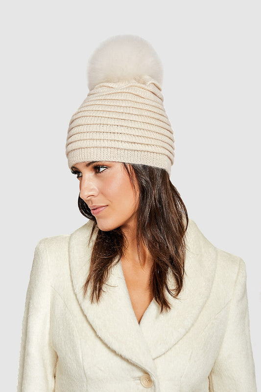 Sentaler Adult Ribbed Hat With Oversized Fur Pompon featured in Baby Alpaca and available in Ivory. Seen from side close up on model.