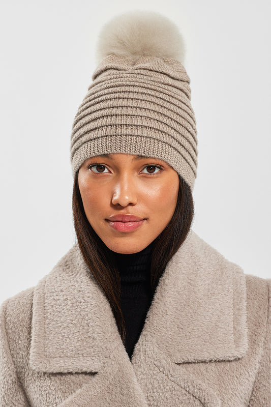 Sentaler Adult Ribbed Hat With Oversized Fur Pompon featured in Baby Alpaca and available in Light Taupe. Seen from front close-up 1.