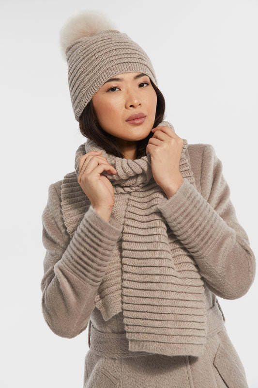 Sentaler Adult Ribbed Hat With Oversized Fur Pompon featured in Baby Alpaca and available in Light Taupe. Seen with scarf.