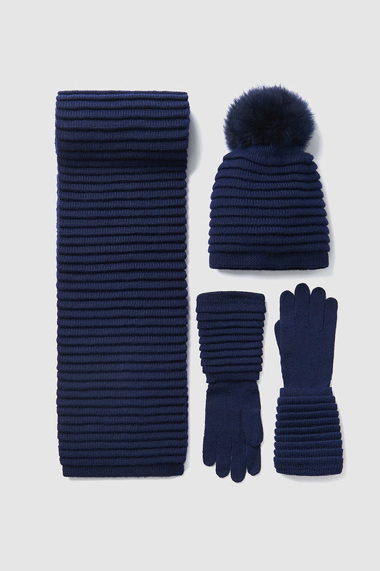 Sentaler Adult Ribbed Hat With Oversized Fur Pompon featured in Baby Alpaca and available in Navy. Seen with scarf and gloves off model.
