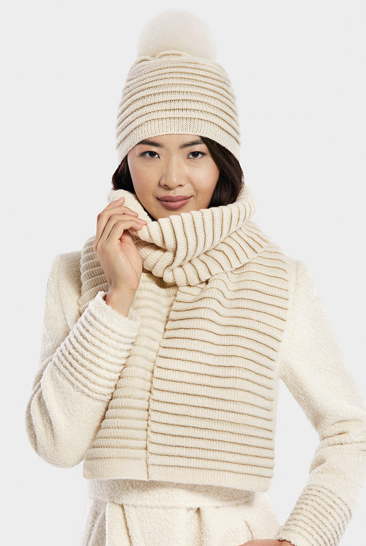 Sentaler Adult Ribbed Hat With Oversized Fur Pompon and Ribbed Scarf featured in Baby Alpaca and available in Ivory. Seen from front on model.