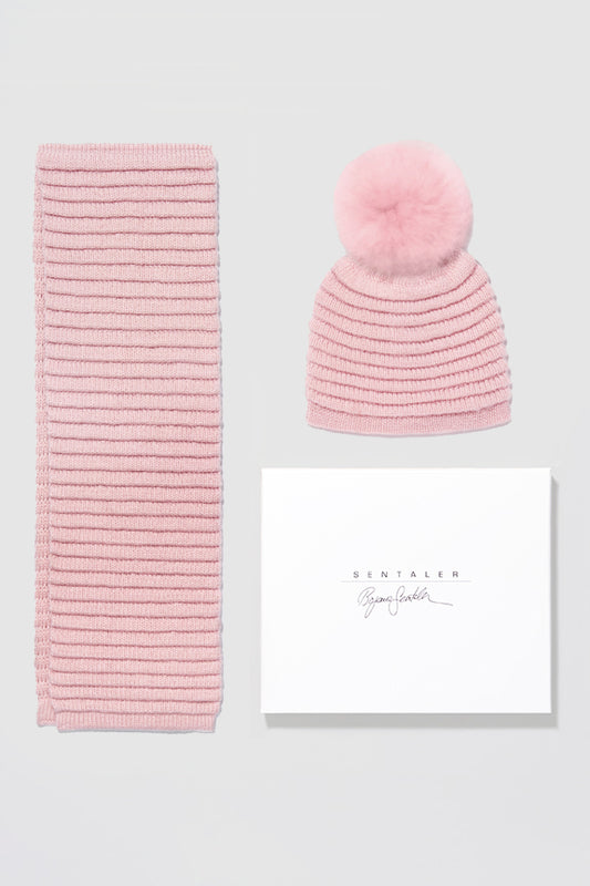 Sentaler Kids (1-5 Years) Ribbed Hat with Oversized Fur Pompon and Ribbed Scarf featured in Baby Alpaca and available in Pink. Seen as off figures.