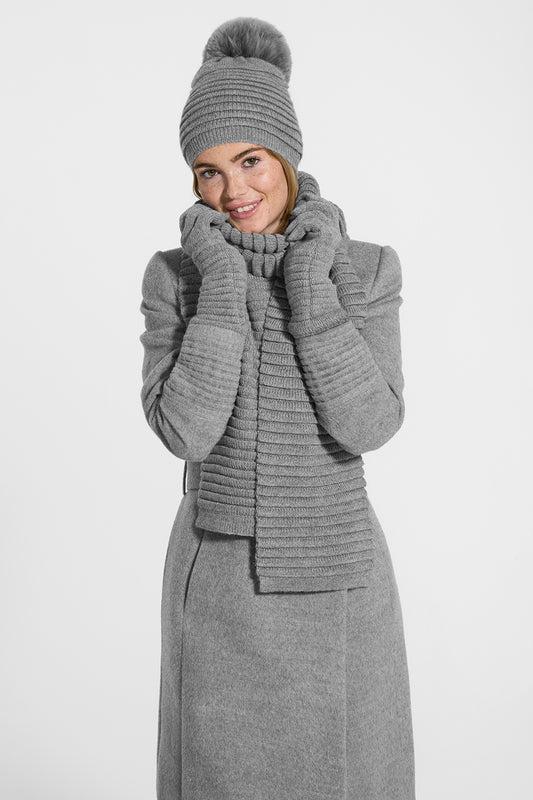 Sentaler Adult Ribbed Hat With Oversized Fur Pompon, Ribbed Scarf and Ribbed Gloves featured in Baby Alpaca and available in Grey. Seen from front on model.
