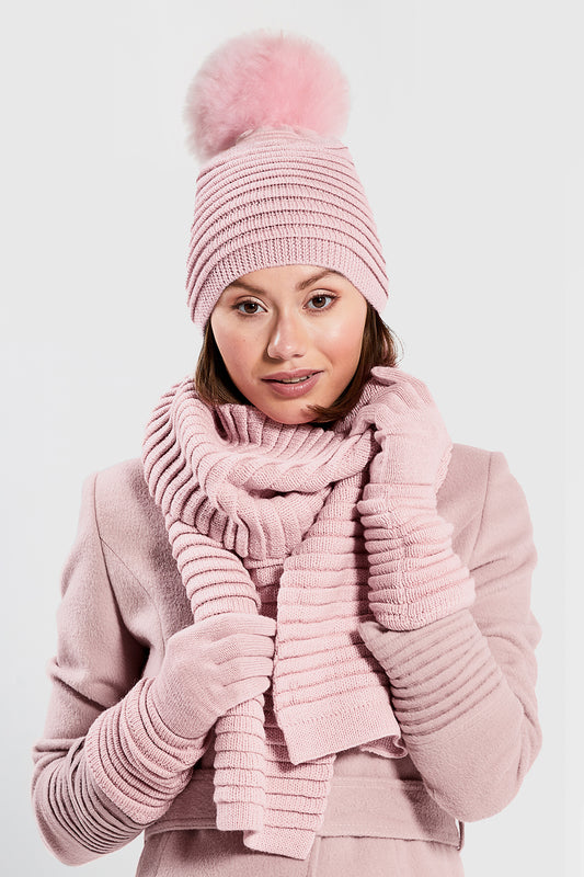 Sentaler Kids (1-5 Years) Ribbed Hat with Oversized Fur Pompon, Ribbed Scarf and Ribbed Scarf featured in Baby Alpaca and available in Pink. Seen from front above the waist on model.