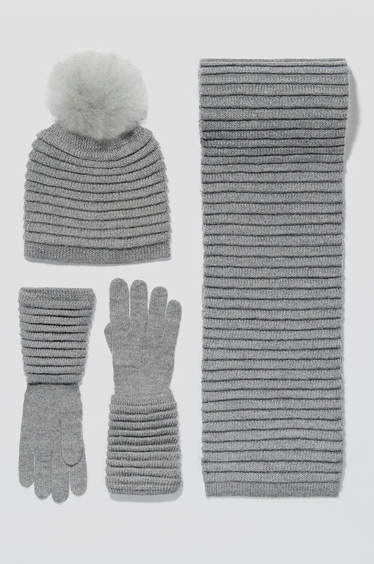 Sentaler Adult Ribbed Gloves, Ribbed Hat with Oversized Fur Pompon and Ribbed Scarf featured in Baby Alpaca and available in Grey. Seen as off figures.
