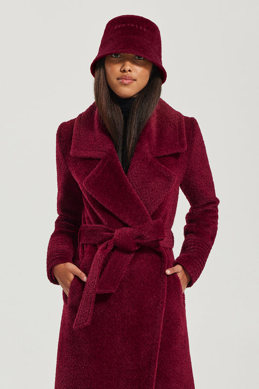 Sentaler Bouclé Alpaca Bucket Hat featured in Bouclé Alpaca and available in Garnet Red. Seen from front above the knee.