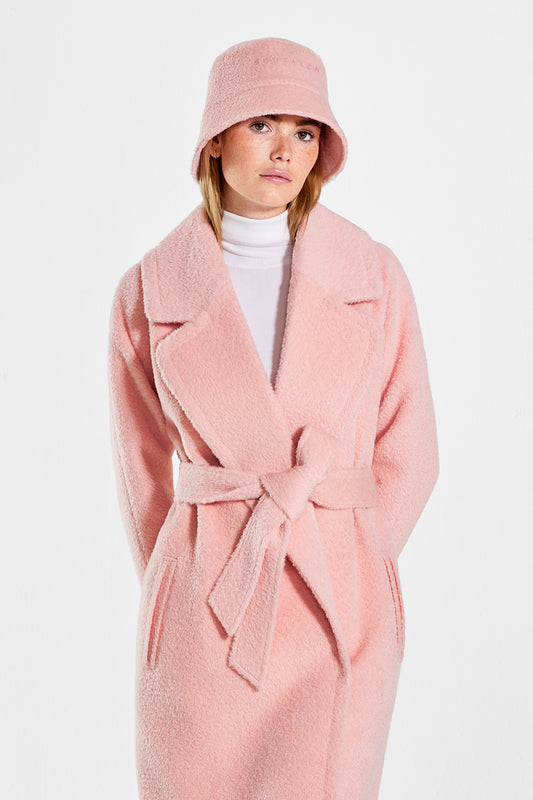 Sentaler Bouclé Alpaca Bucket Hat featured in Bouclé Alpaca and available in Pink Clay. Seen from front above the knees on model.