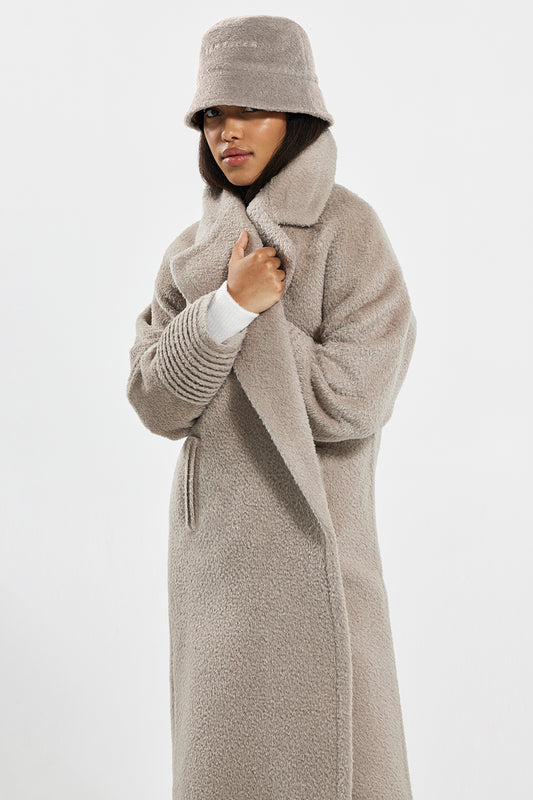 Sentaler Bouclé Alpaca Bucket Hat featured in Bouclé Alpaca and available in Sand. Seen from front above knee.