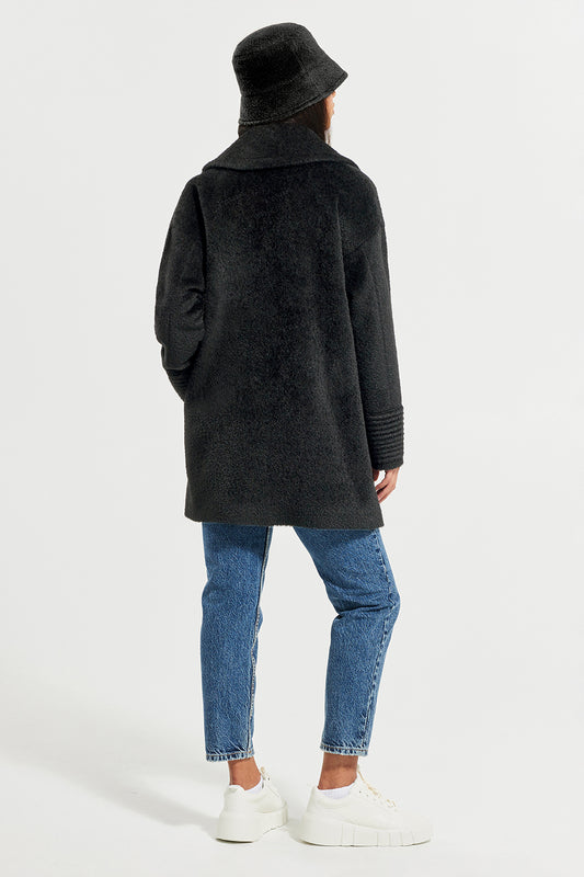 Sentaler Bouclé Alpaca Bucket Hat and Bouclé Alpaca Mid Length Oversized Notched Collar Coat featured in Bouclé Alpaca and available in Black. Seen from back on model.
