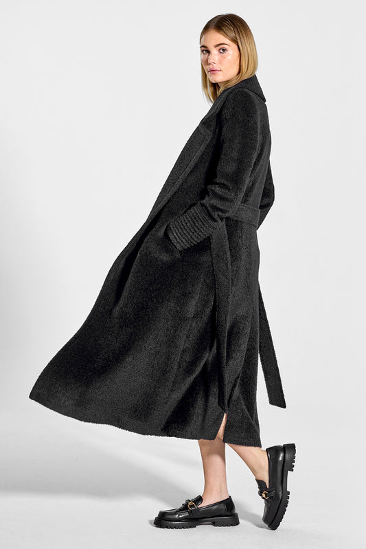 Sentaler Bouclé Alpaca Long Notched Collar Wrap Coat featured in Bouclé Alpaca and available in Black. Seen from side open on model.