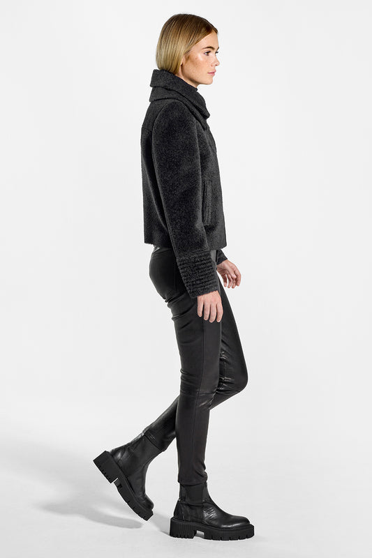 Sentaler Bouclé Alpaca Moto Jacket with Signature Double Collar featured in Bouclé Alpaca and available in Black. Seen from side on model.