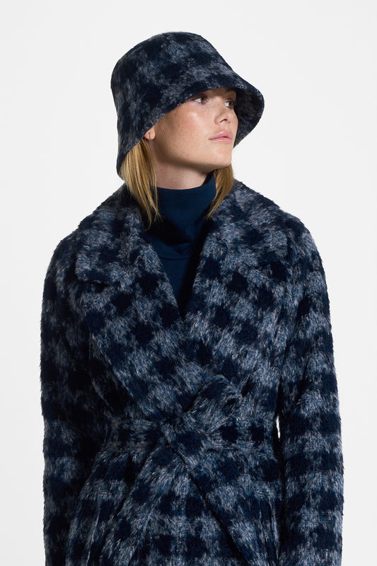 Sentaler Houndstooth Suri Alpaca Bucket Hat featured in Suri Alpaca and available in Navy Houndstooth. Seen from side close up on model.