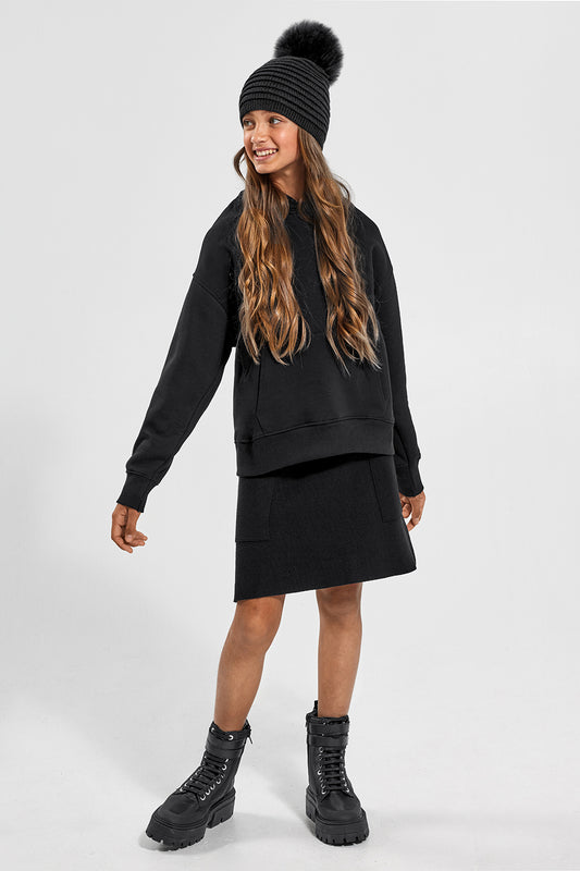 Sentaler Kids (6-14 Years) Ribbed Hat with Oversized Fur Pompon featured in Baby Alpaca and available in Black. Seen from front on model.