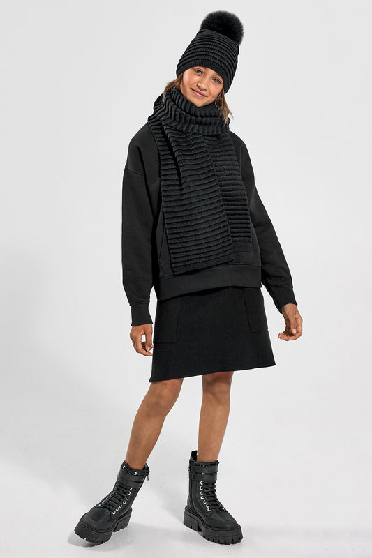 Sentaler Kids (6-14 Years) Ribbed Hat with Oversized Fur Pompon and Ribbed Scarf featured in Baby Alpaca and available in Black. Seen from front on model.