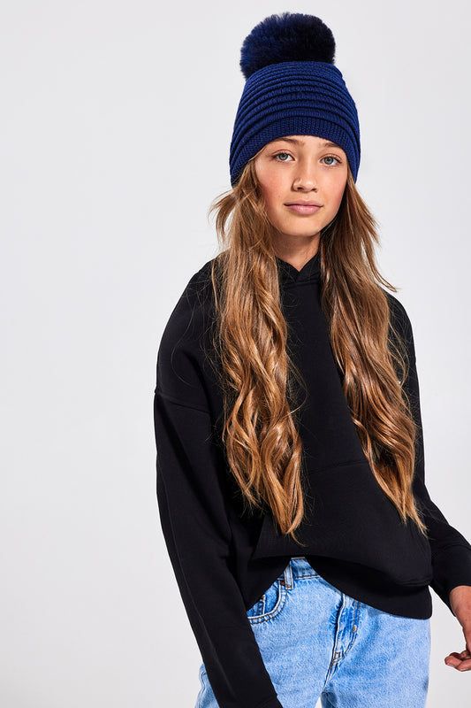 Sentaler Kids (6-14 Years) Ribbed Hat with Oversized Fur Pompon featured in Baby Alpaca and available in Navy. Seen from front.