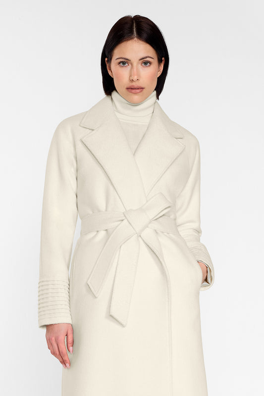 Sentaler Long Notched Collar Raglan Sleeve Wrap Coat featured in Baby Alpaca and available in Ivory. Seen from front above the knees on female model wearing the coat belted.