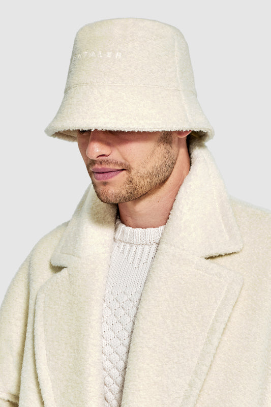 Sentaler Mens Bouclé Alpaca Bucket Hat featured in Bouclé Alpaca and available in Ivory. Seen from side close up on model.